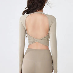 Backless long-sleeve crop top for yoga/fitness.