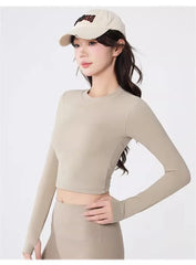 Backless long-sleeve crop top for yoga/fitness.