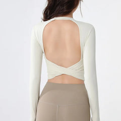 Backless long-sleeve crop top for yoga/fitness.