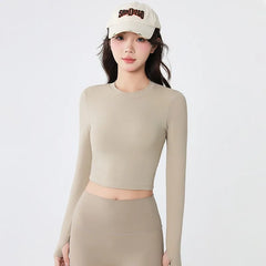 Backless long-sleeve crop top for yoga/fitness.