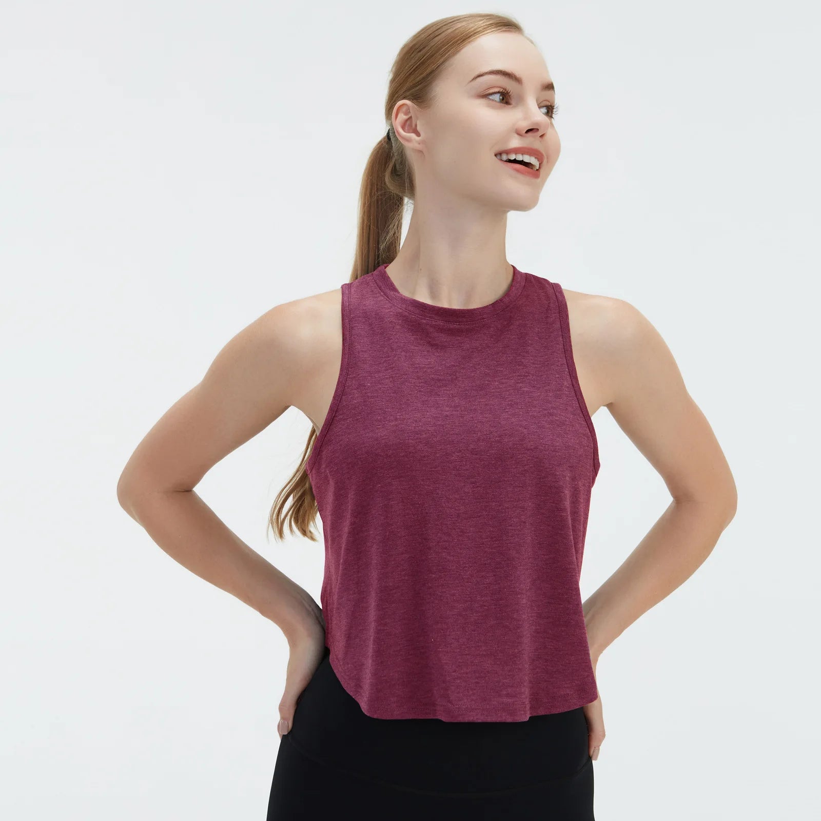 Sleeveless BeFit Yoga and Fitness Tank Top in [ Burgundy]. Shows a comfortable, breathable fit perfect for studio stretching and running.