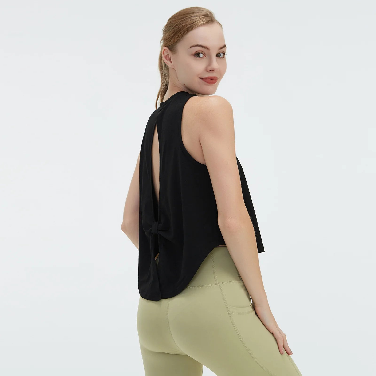  Sleeveless BeFit Yoga and Fitness Tank Top in [Black]. Shows a comfortable, breathable fit perfect for studio stretching and running.