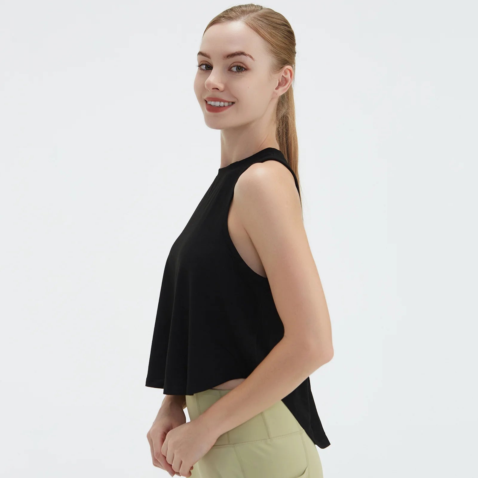  Sleeveless BeFit Yoga and Fitness Tank Top in [Black]. Shows a comfortable, breathable fit perfect for studio stretching and running.