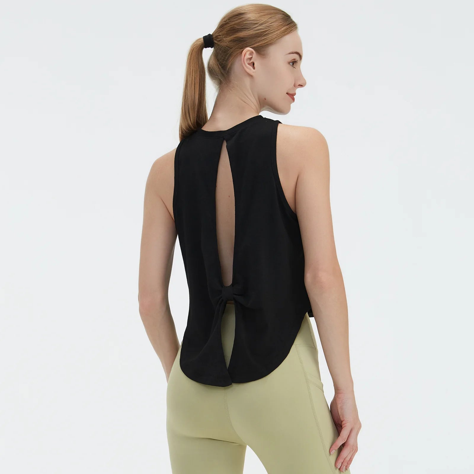  Sleeveless BeFit Yoga and Fitness Tank Top in [Black]. Shows a comfortable, breathable fit perfect for studio stretching and running.