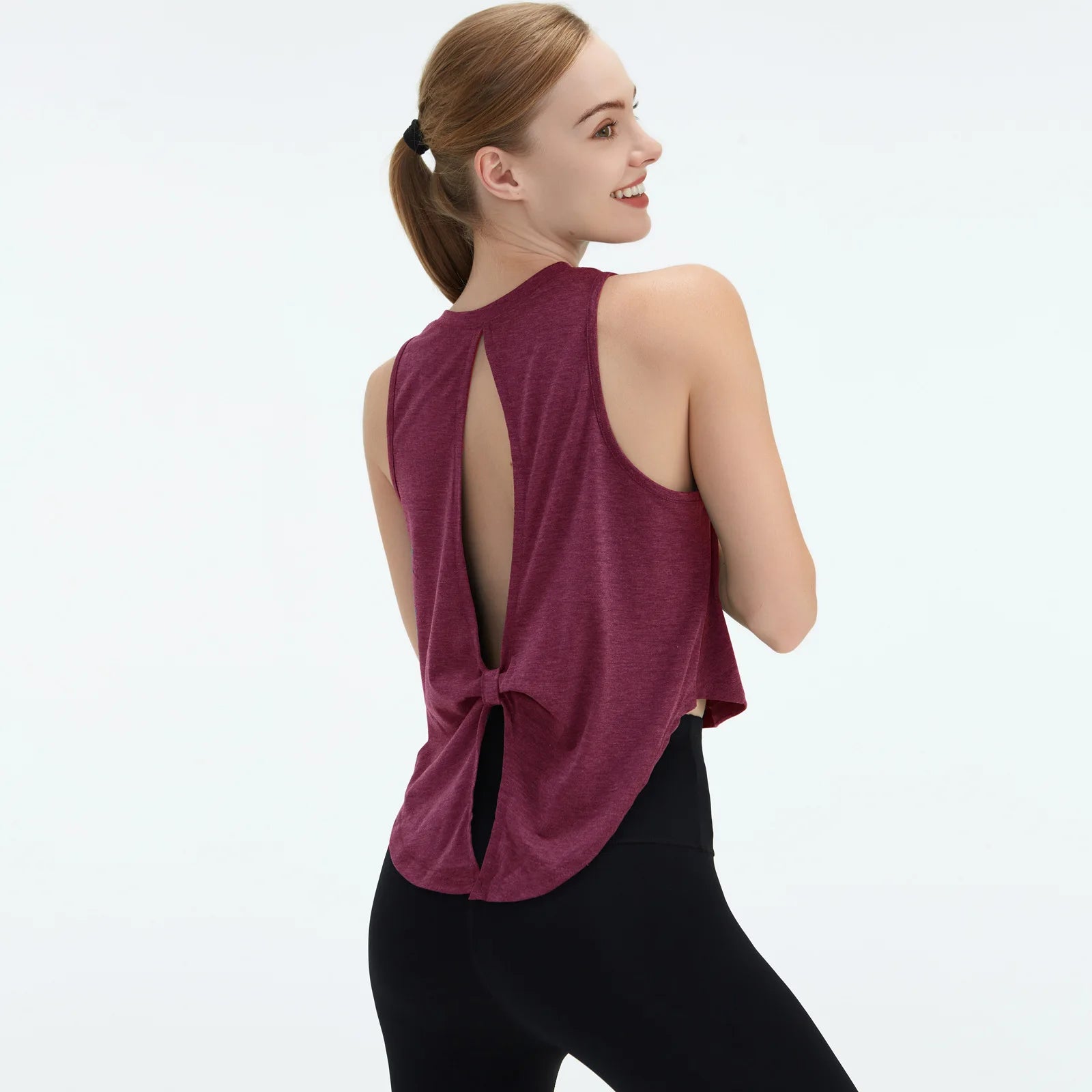  Sleeveless BeFit Yoga and Fitness Tank Top in [ Burgundy]. Shows a comfortable, breathable fit perfect for studio stretching and running.