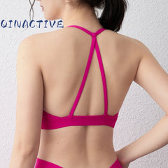 Woman in QINACTIVE sports bra designed for comfort and active movement

