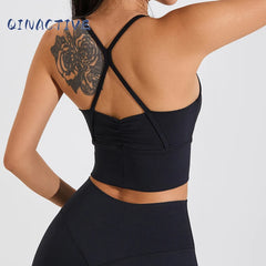 Woman in black QINACTIVE stylish pleated yoga bra


