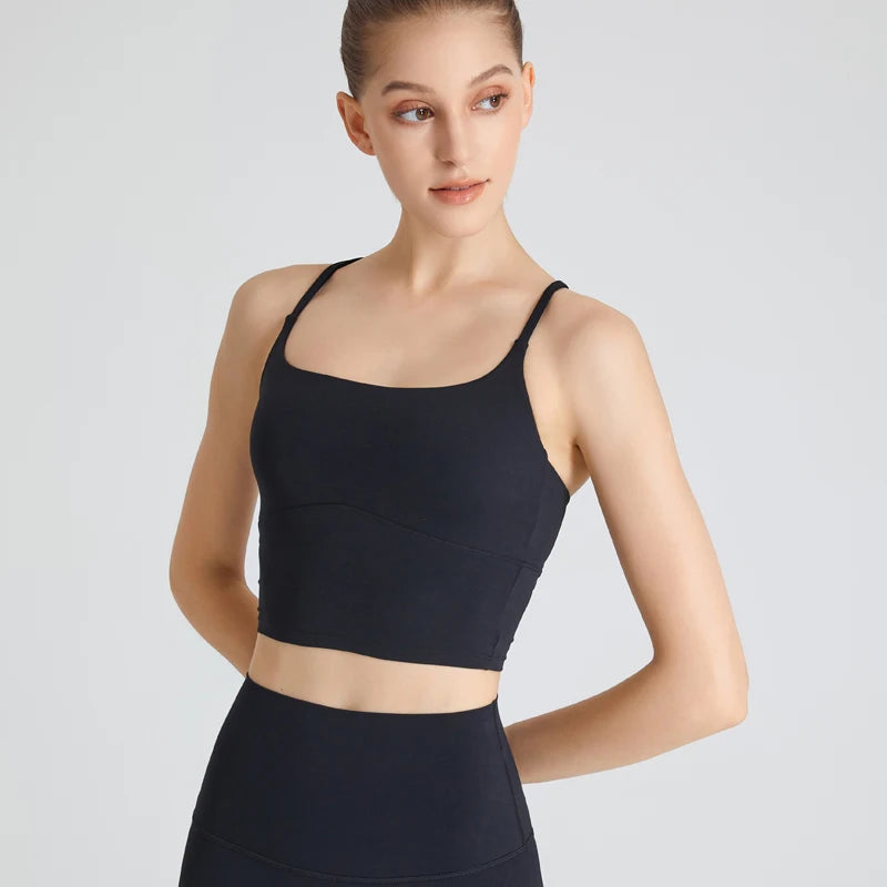 Woman wearing black B-Fit one-shoulder sports bra for yoga and fitness

