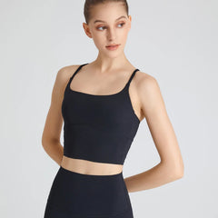 Woman wearing black B-Fit one-shoulder sports bra for yoga and fitness

